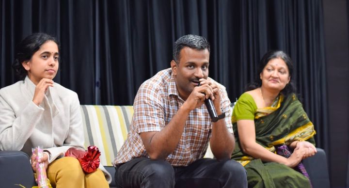 Dr. Karthikeyan Balakumar sitting in a panel discussion for Women's day